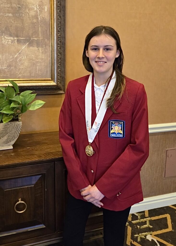 Alexis Squyers in a SkillsUSA Red Blazer and a gold medal around her neck.